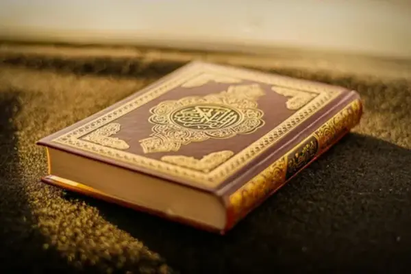 who wrote the quran and when was it written